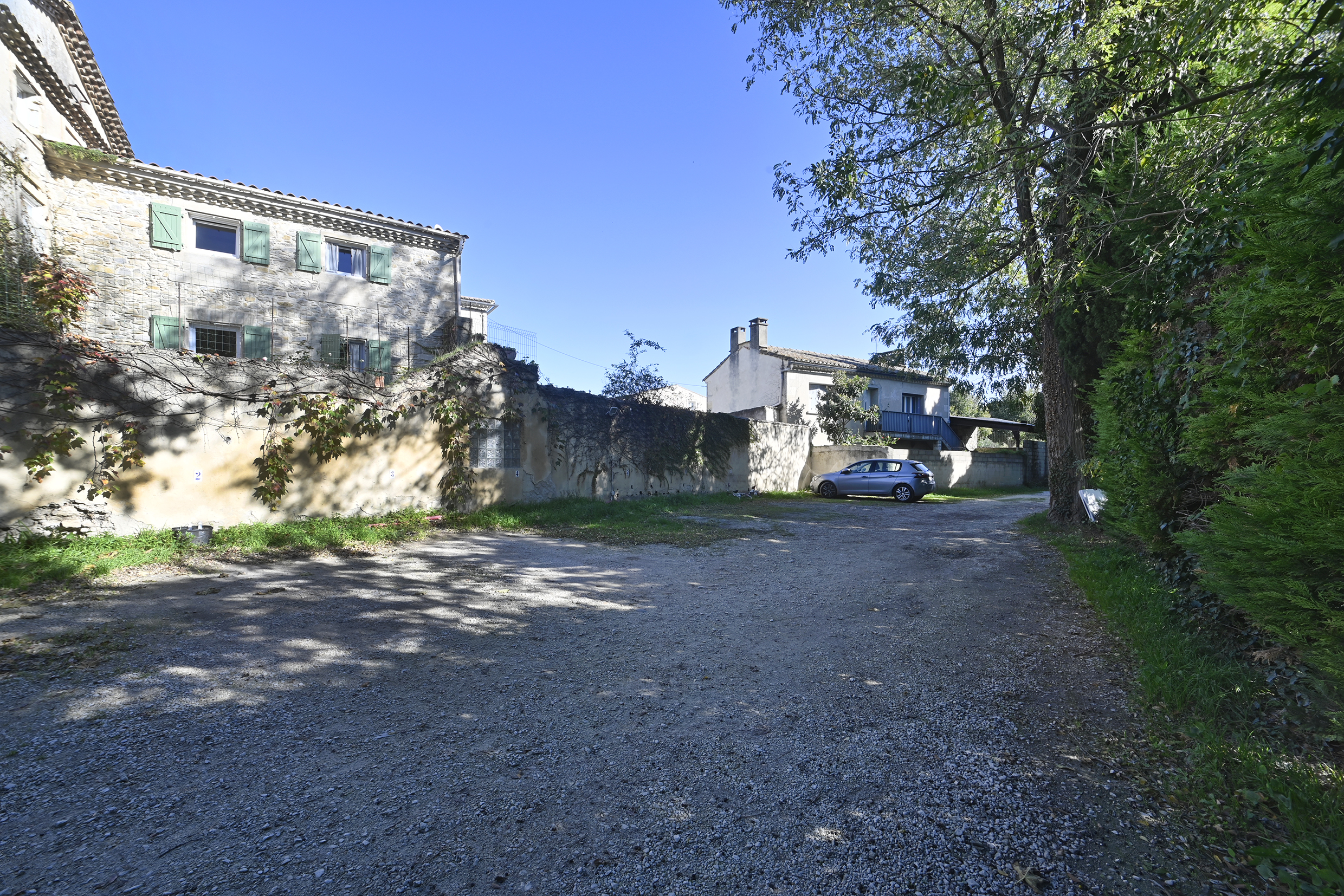Cour extérieure avec stationnement et façade de la résidence